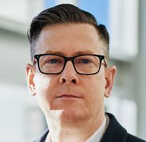 Alexander Hughes, CEO at a crypto trading company, portrait.